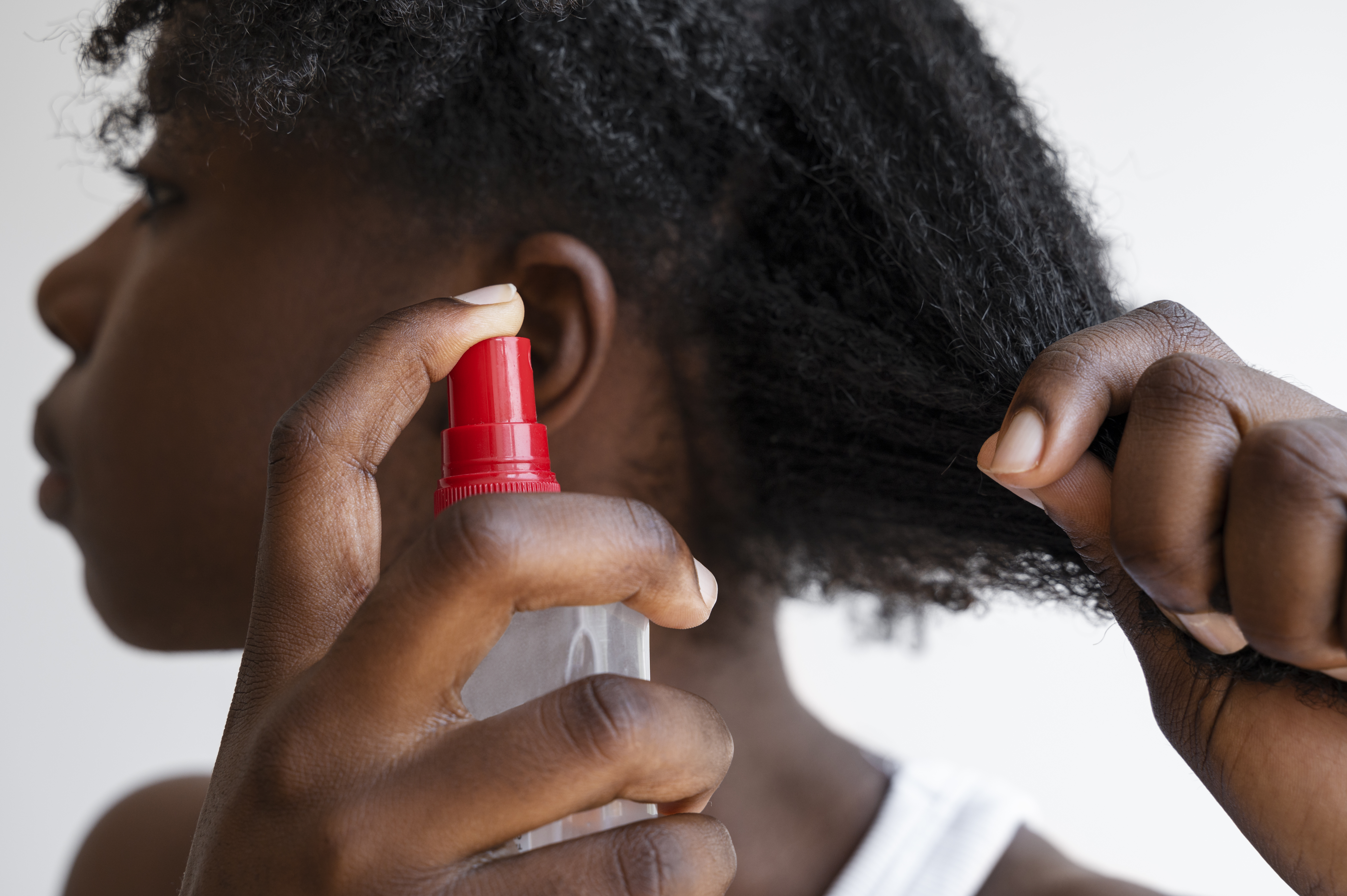 side view woman using hair product