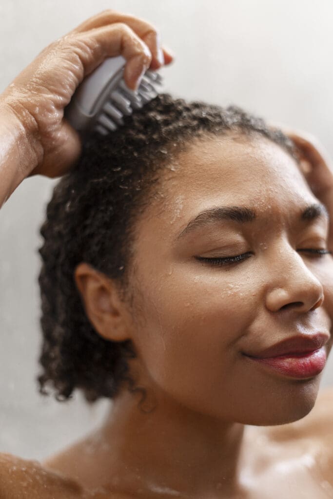 woman giving herself scalp massage