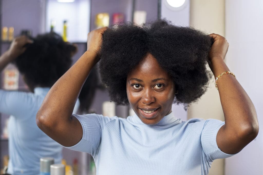 woman taking care her afro hair